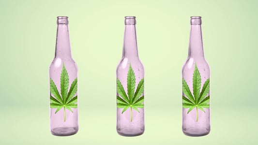 Three glasses bottles, each with a cannabis leaf on it.