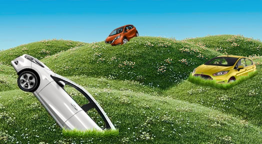 Three cars (white, orange, yellow) are humorously shown partially buried or sinking into lush green, flower-speckled hills, implying market challenges.