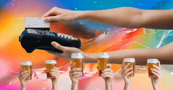 A credit card is run through a machine while 6 hands hold up glasses of beer in the foreground.