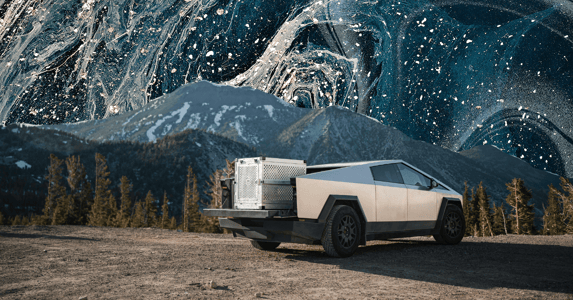 A Tesla Cybertruck in front of a mountain range