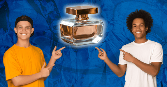 Two teenage boys pointing to a bottle of perfume.