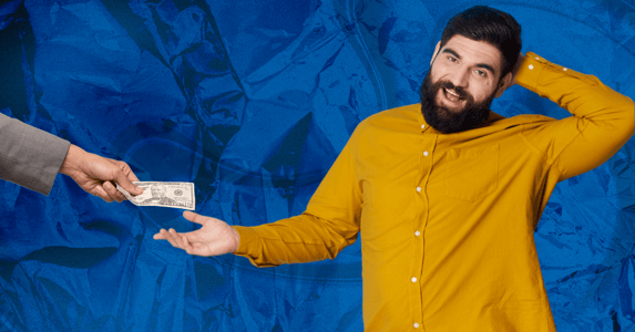 A man holds out his hand to accept a $50 bill.