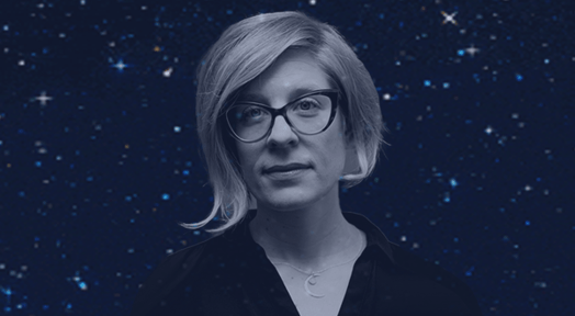 A portrait of Kathryn Nicolai, a woman with short blonde hair and cat-eye glasses, set against a dark, starry background.